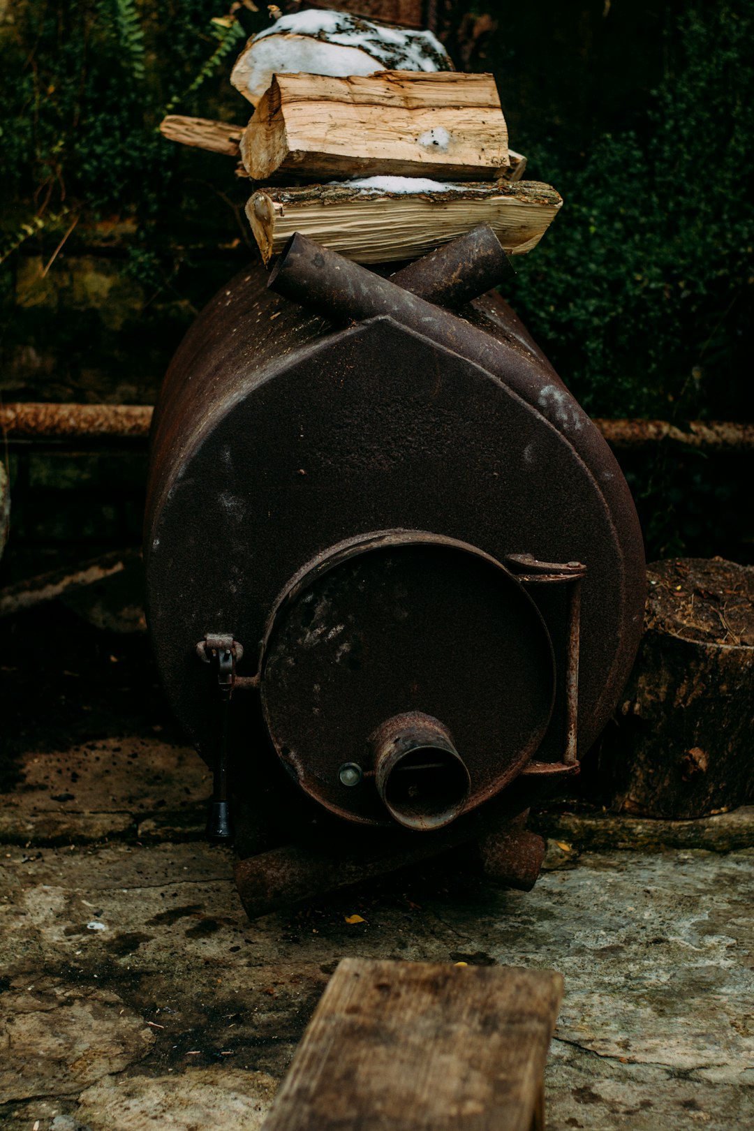 black metal round container on gray concrete floor