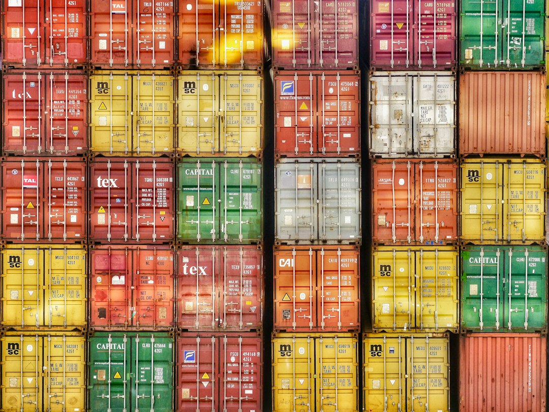 A wall of stacked colorful shipping containers